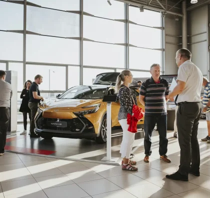 Návštěvníci si prohlížejí vůz v showroomu